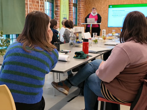 Participants at the network meeting sit at one table