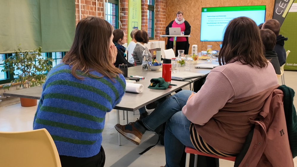Participants at the network meeting sit at one table
