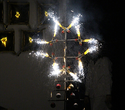 A star-shaped firework display lights up the stage.