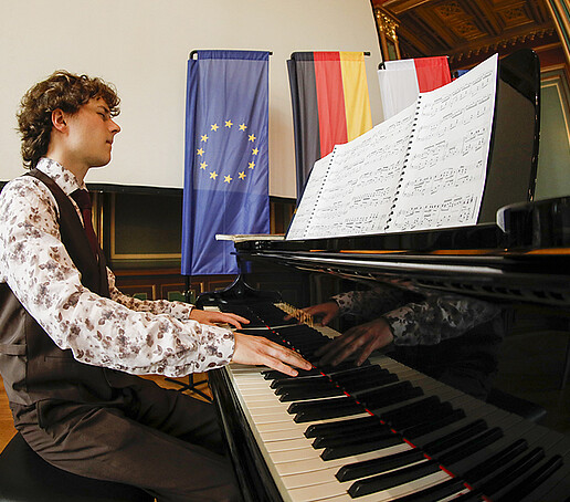 The pianist plays the piano.
