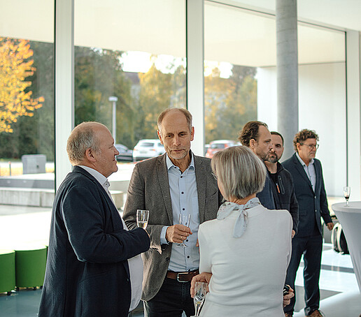 Guests at the event are engrossed in conversation.