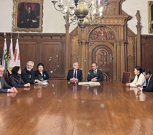 The delegation from the university and Mongolia sit with Mayor Ursu at a wooden table in Görlitz town hall.