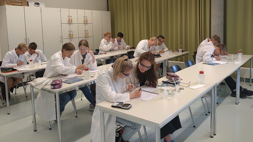 Pupils sit experimenting in the lab