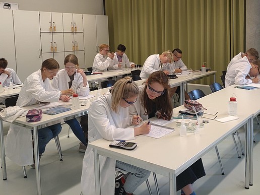 Pupils sit experimenting in the lab