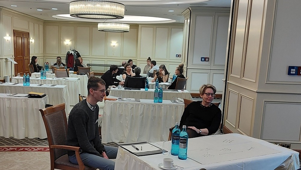 different people sit at discussion tables