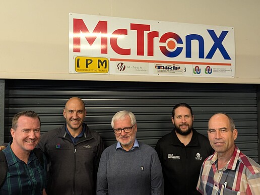 Prof. Worlitz (center) with Prof. Kenny Uren (left) and other NWU colleagues in front of the NWU mechatronics lab
