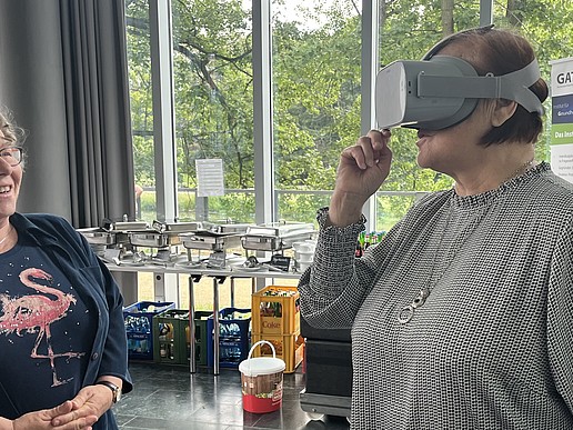 An older woman tries out VR glasses.