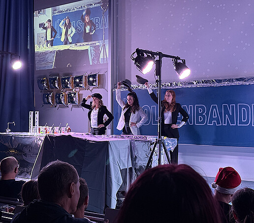 Three dancers dance on stage.