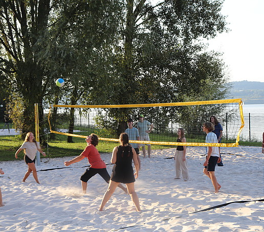 Students play volleyball at Lake Berzdorf.