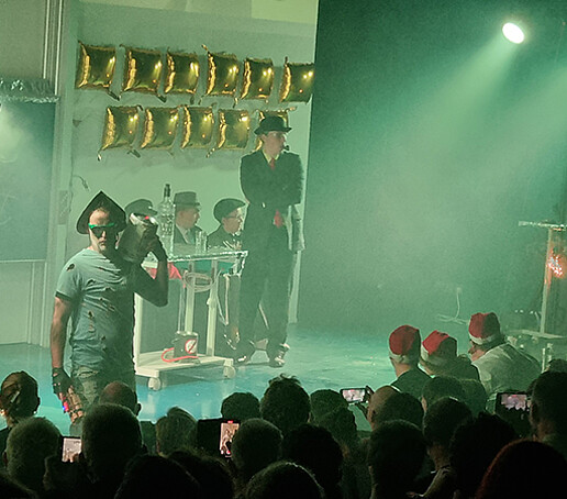 Performers on stage are in the green light.