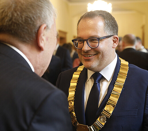 The Rector accepts congratulations from a guest.