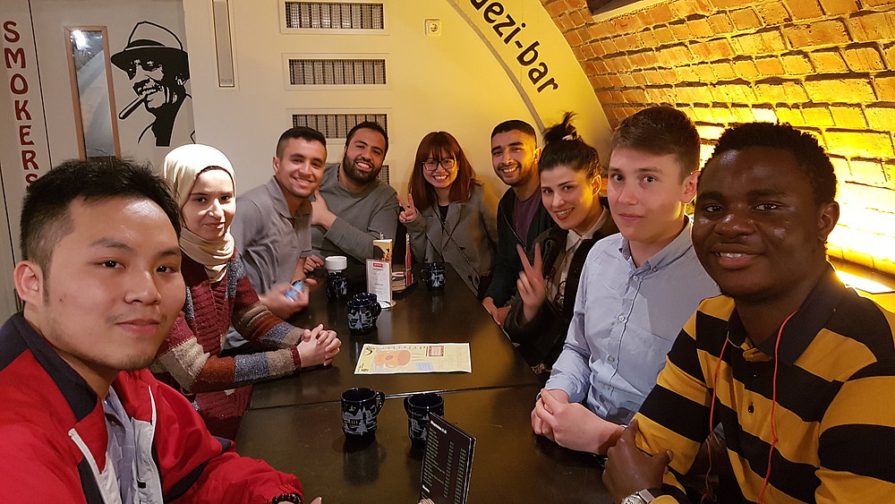 Group of students of different nationalities in a bar