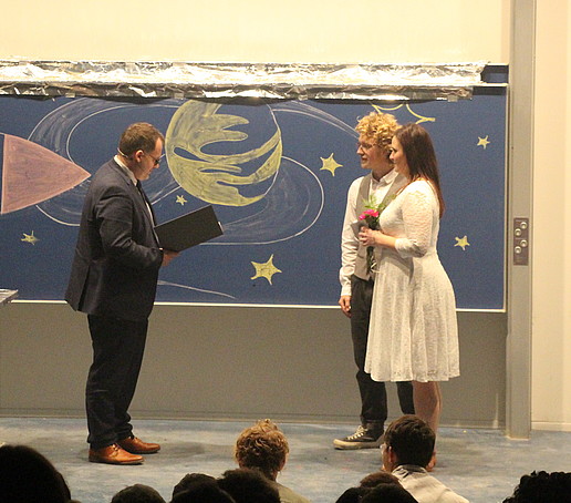The rector marries Grace and AJ on stage.