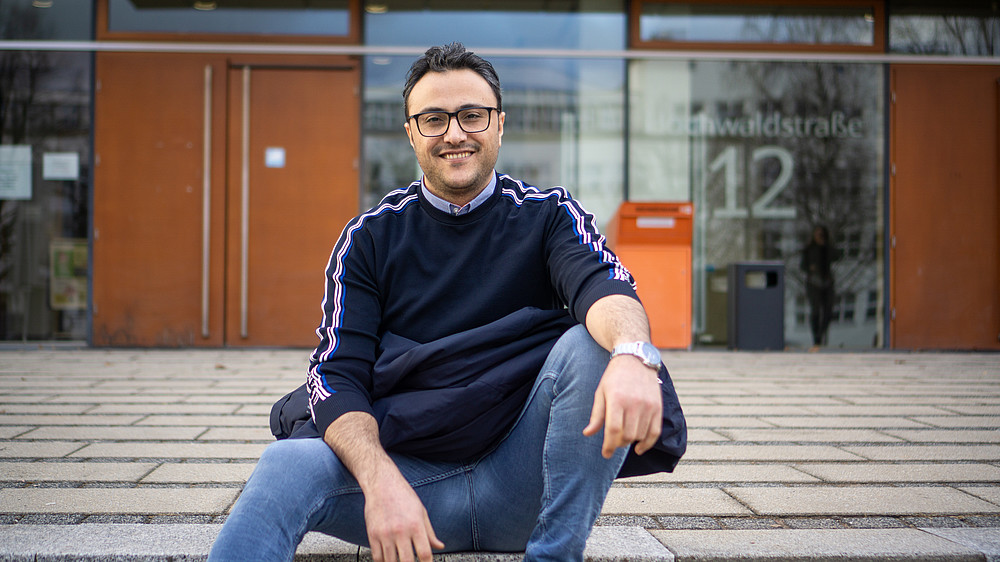 Ali Al Hamad sits on the staircase in front of the Zittau canteen.