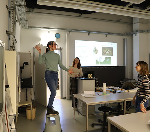 A pupil flies a paper airplane in the materials laboratory.