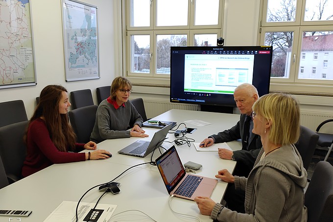 Maren Molch sits in a meeting with DPR representatives in the consultation room.