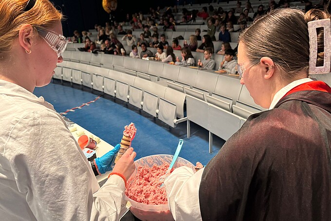 Two actresses prepare ice cream.