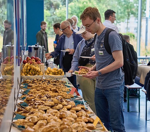 A photo of the coffee and cake buffet with people