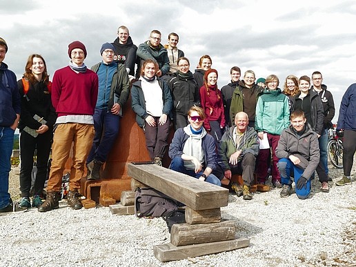 A group of students and a professor in a stony landscape.