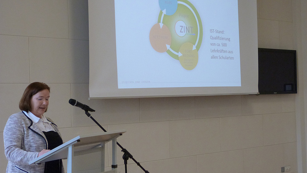 Woman stands at the lectern and gives a lecture