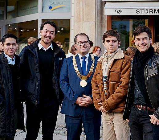 Rector with chain of office and students