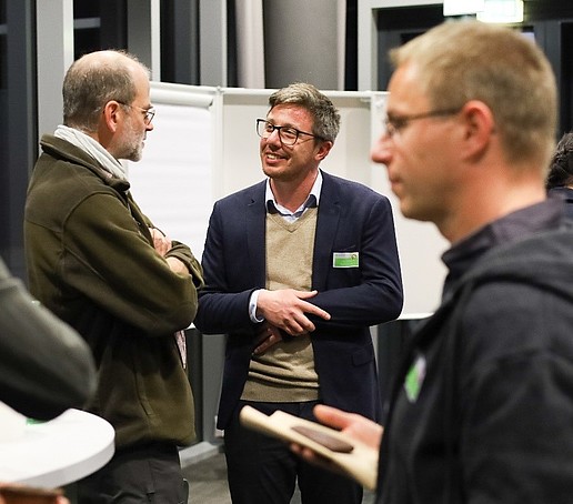 A group of university employees in conversation