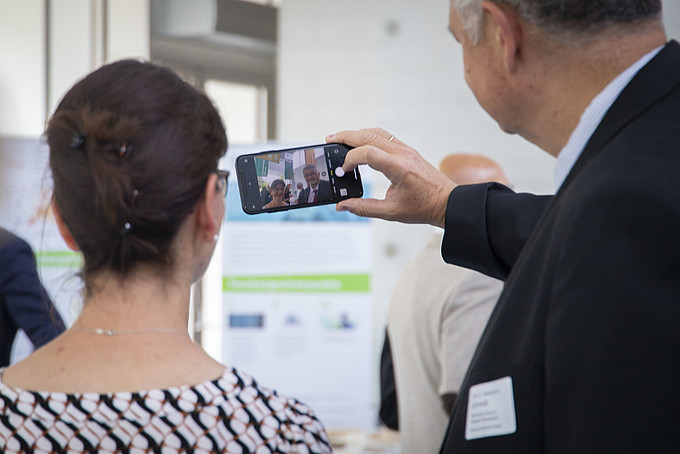 Guests take a selfie with a smartphone.