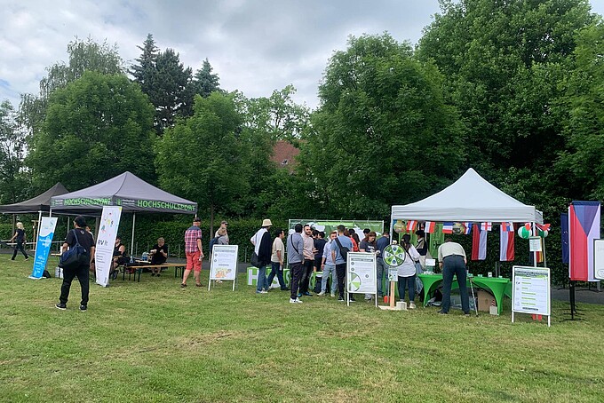 Participants celebrate on the festival meadow between pavilions.