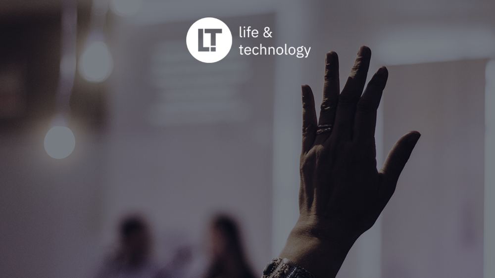 A hand stretches upwards. The Life and Technology logo can still be seen.