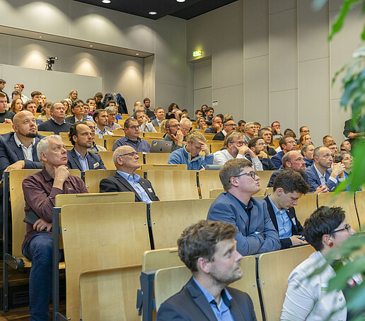 The rows of seats are filled with people looking ahead.