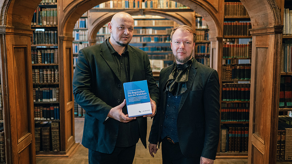 Prof. Matthias Schmidt and Tino Schmidt in a library.