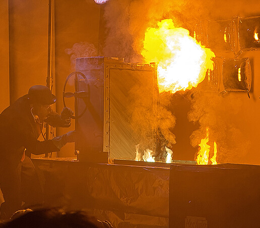 A fountain of fire spurts up behind the safe.