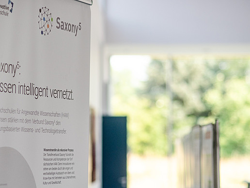 A Saxony5 roll-up stands in a hall with a view of the countryside.