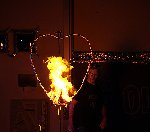 A fire experiment in the shape of a heart is observed by Mr. Jeschke.