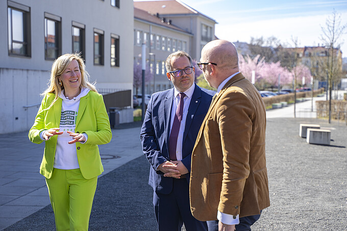 Vice President, Rector and Mr. Denk walk along the Zittau campus and talk.