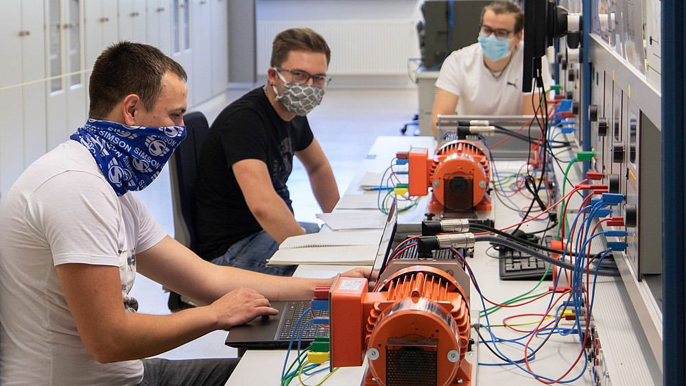 Three students with face masks during their internship