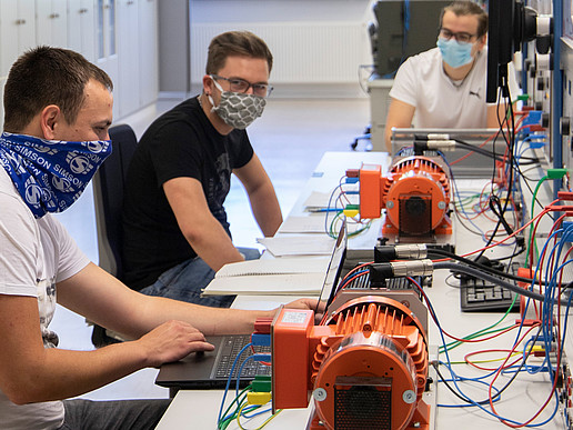 Three students with face masks during their internship