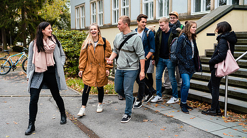 Eine Gruppe fröhlicher Studierender verlässt ein Lehrgebäude. Absolvent*innen mit hervorragenden Abschlussarbeiten können sich Hoffnung auf eine Auszeichnung vom Förderverein der HSZG machen.