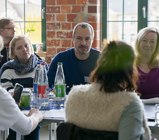 The conference participants sit at the table.