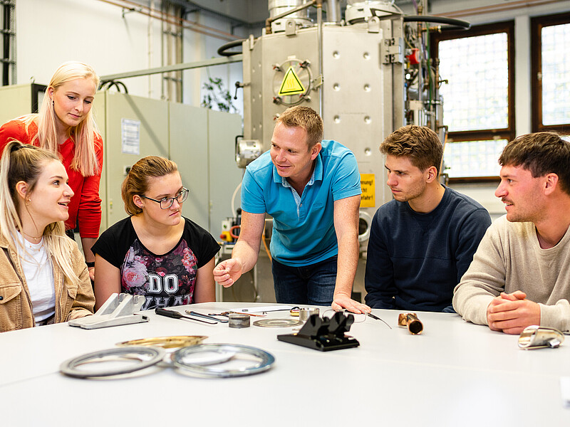 Students sit in the Mechanical Engineering lab and listen to a lecturer.