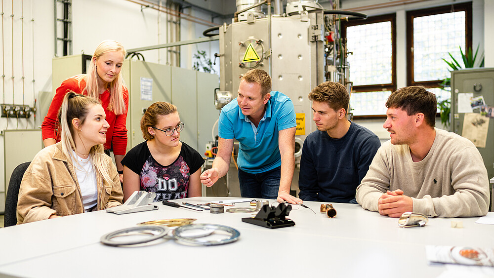 Students sit in the Mechanical Engineering lab and listen to a lecturer.