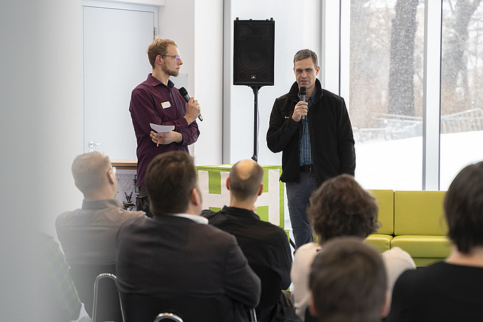Two speakers in front of an audience