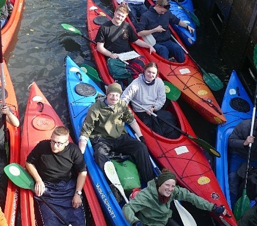 Students sit in paddle boats.
