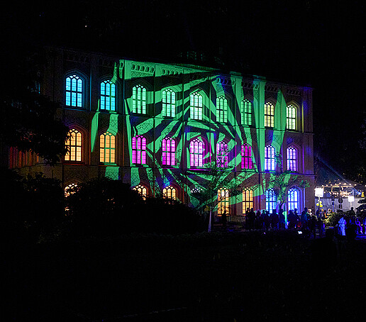 The stitching gable is illuminated in green, purple and yellow.