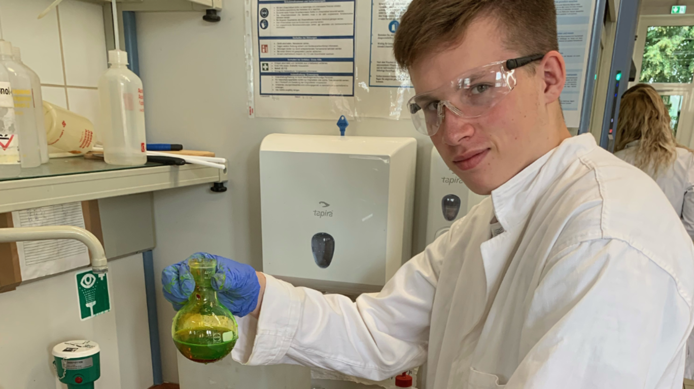 Young man shows a container with chemical