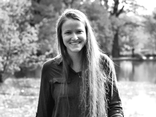 Stella Silbermann smiles as she walks along a jetty by a lake.