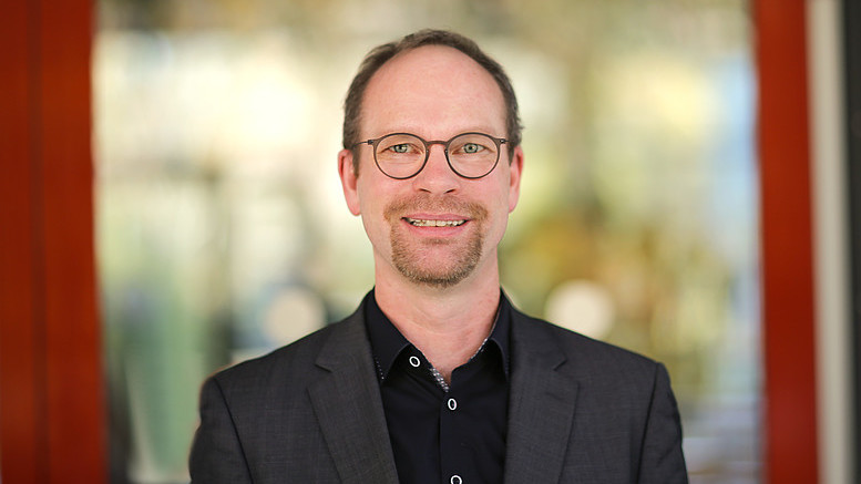 Prof. Hoff smiles into the camera.