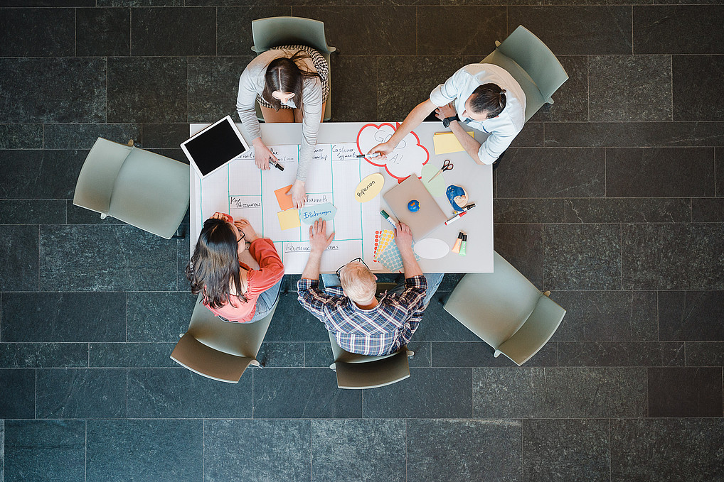 Studying international business communication in Görlitz. Top view of a student group at the table.