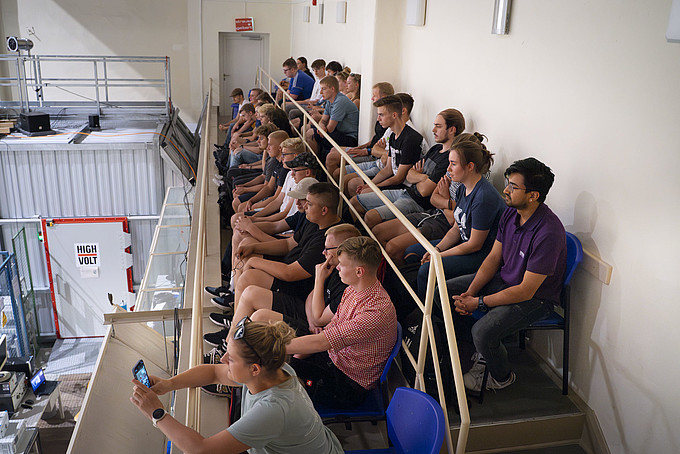 Dual students on seats in the high-voltage hall