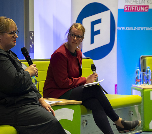 A woman on the sofa with a microphone.